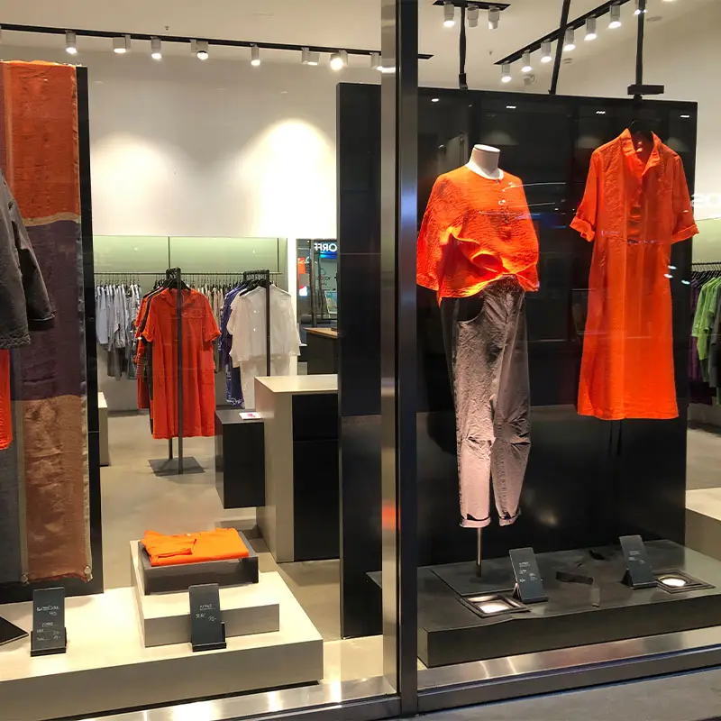 Fashion display featuring vibrant orange clothing items.