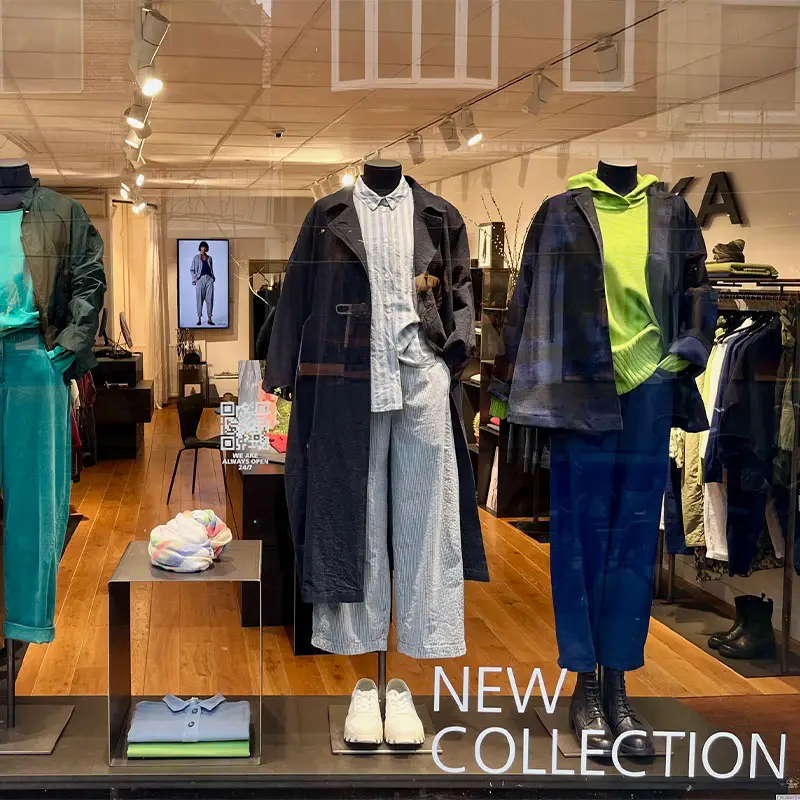 Display of new clothing collection in store window.