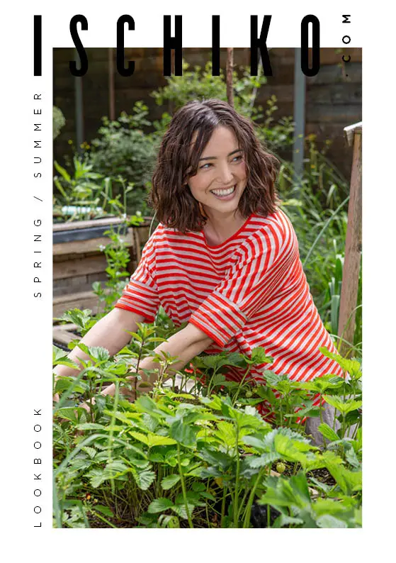 Smiling model in a red striped top in a garden