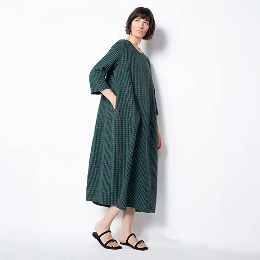 Model wearing a green plaid oversized dress.