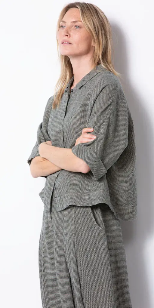 Person in stylish green checkered outfit.