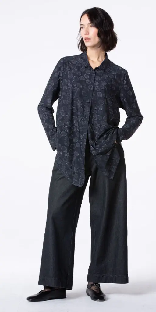 Woman wearing a stylish oversized shirt and pants.