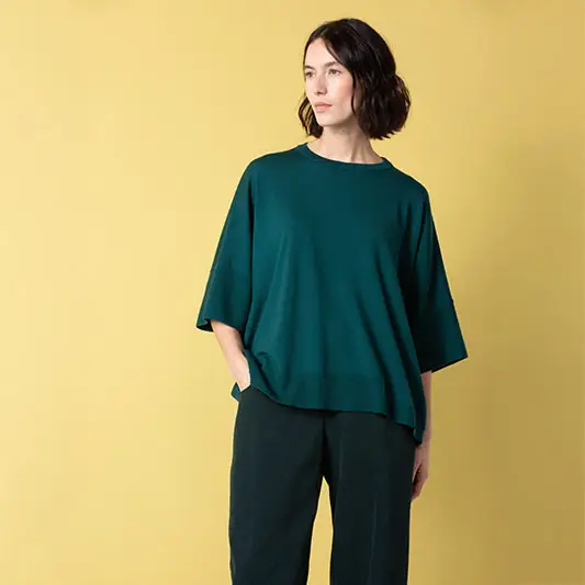 Woman in green top against yellow background