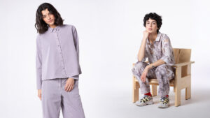 Two women modeling stylish outfits in a minimalist setting.
