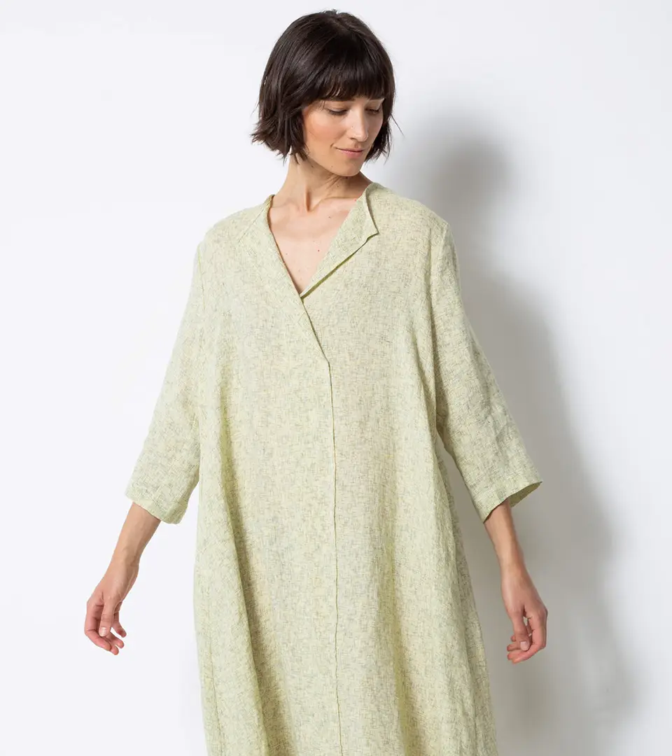 Woman in a light green oversized linen dress