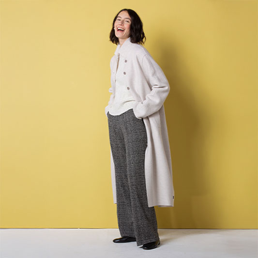 Smiling woman in stylish winter outfit.