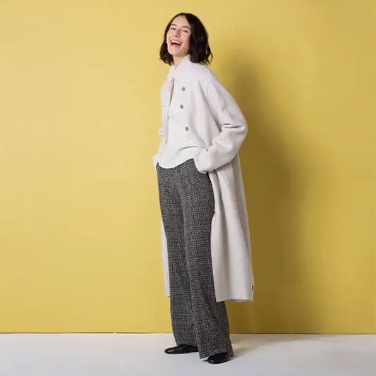 Smiling woman in stylish winter outfit.