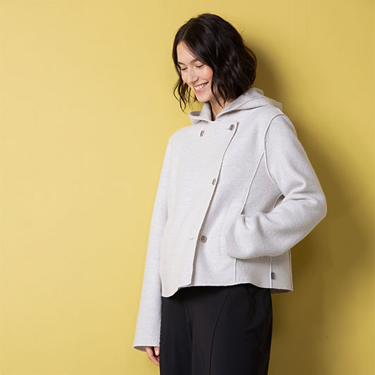 Woman wearing a light hooded jacket