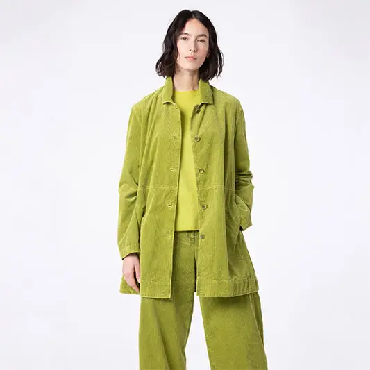 Model wearing a stylish green outfit.