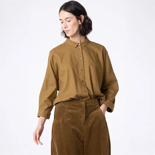 Woman modeling a stylish brown outfit.