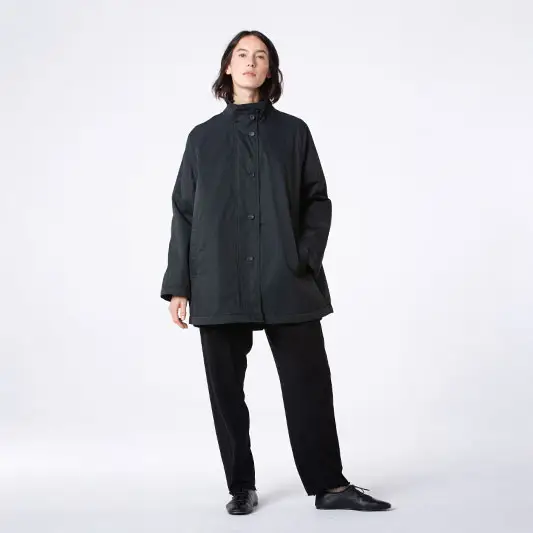 Person in a black coat and pants.