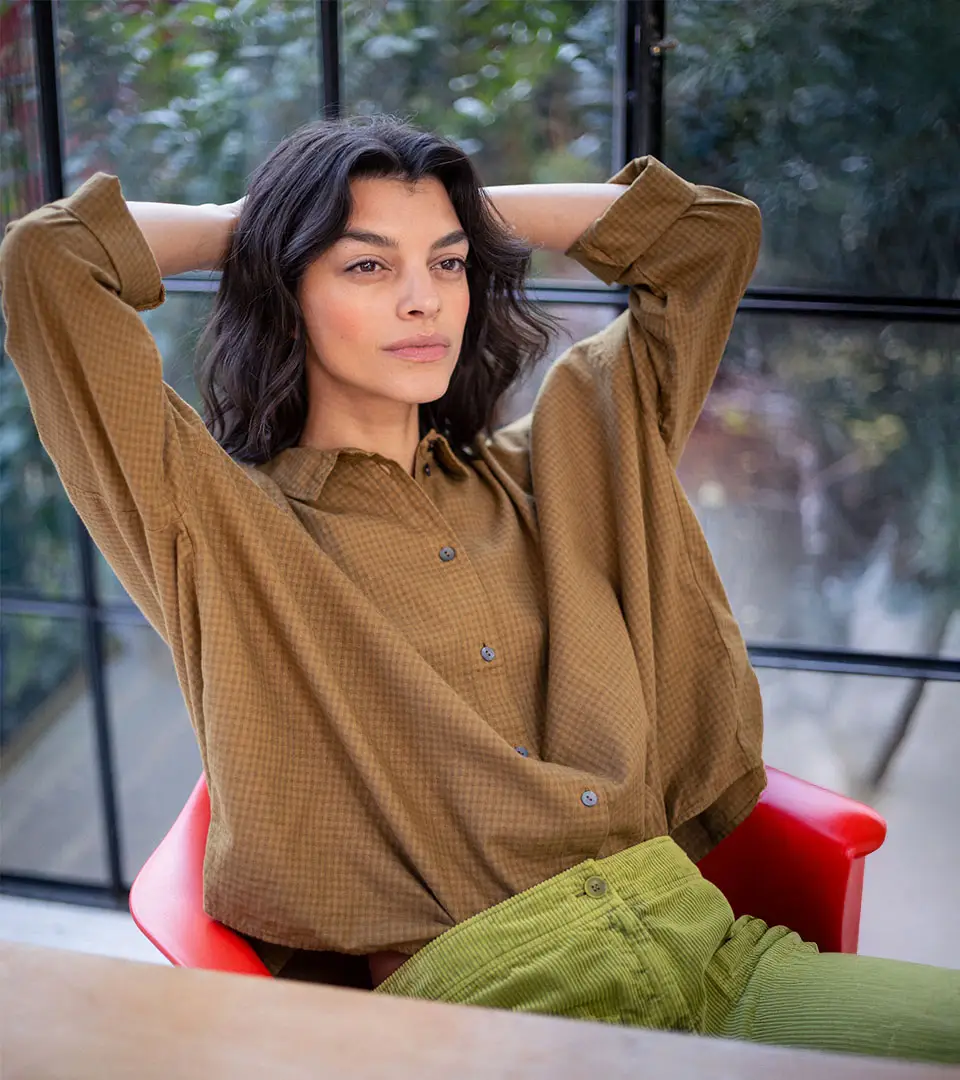 Woman relaxing in a stylish outfit.