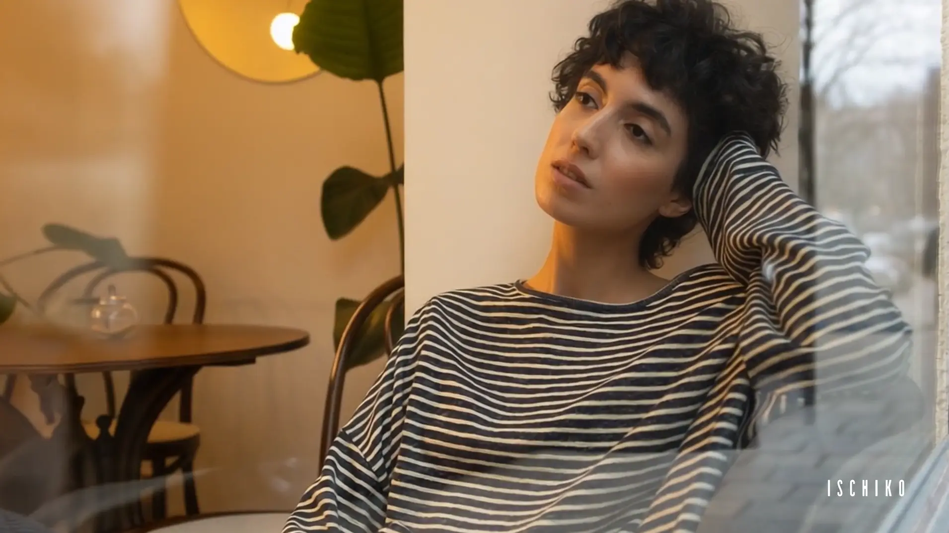 Thoughtful person in a cozy indoor setting.