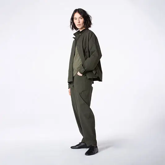 Model in stylish olive green outfit.