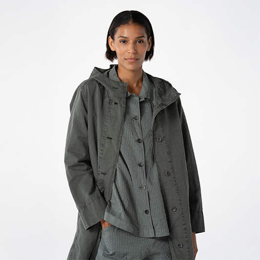 Woman wearing a stylish gray coat.