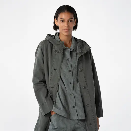 Woman wearing a stylish gray coat.