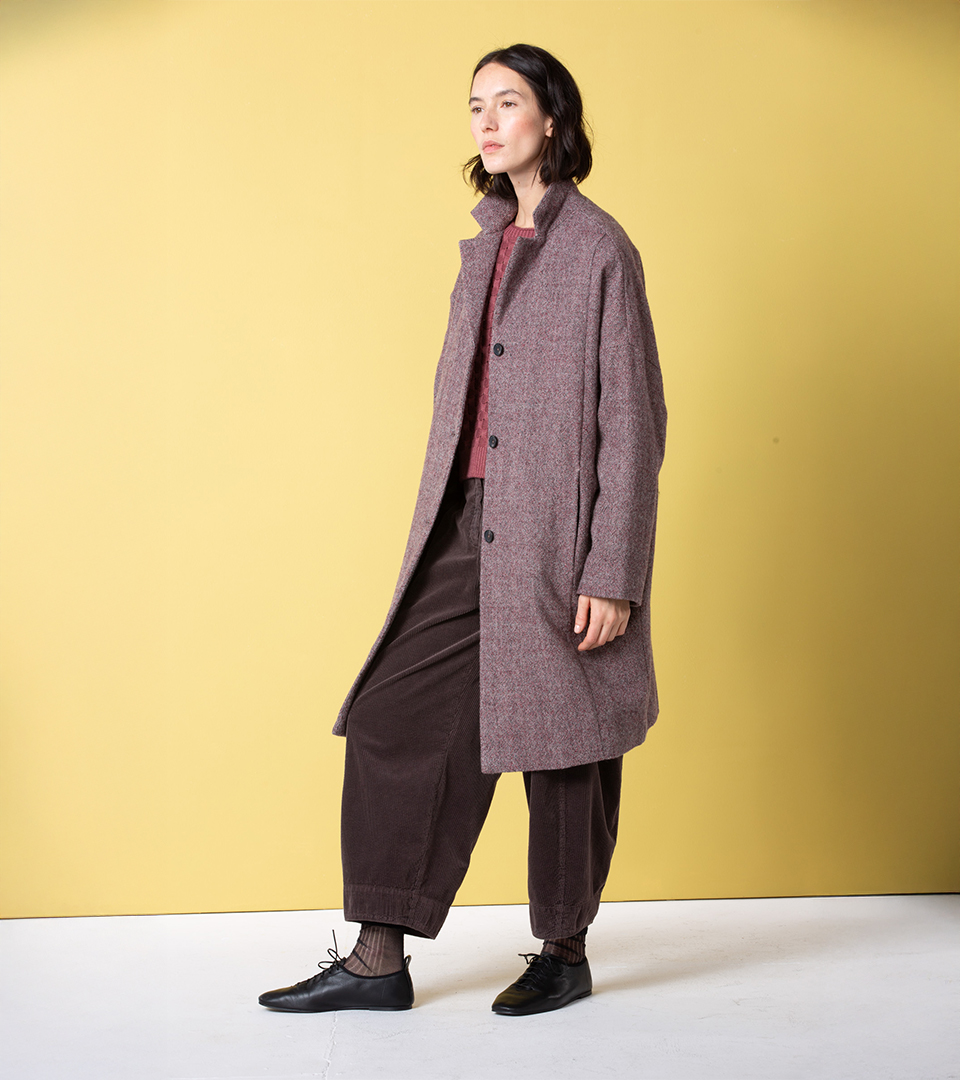 Woman wearing a stylish brown coat and pants.