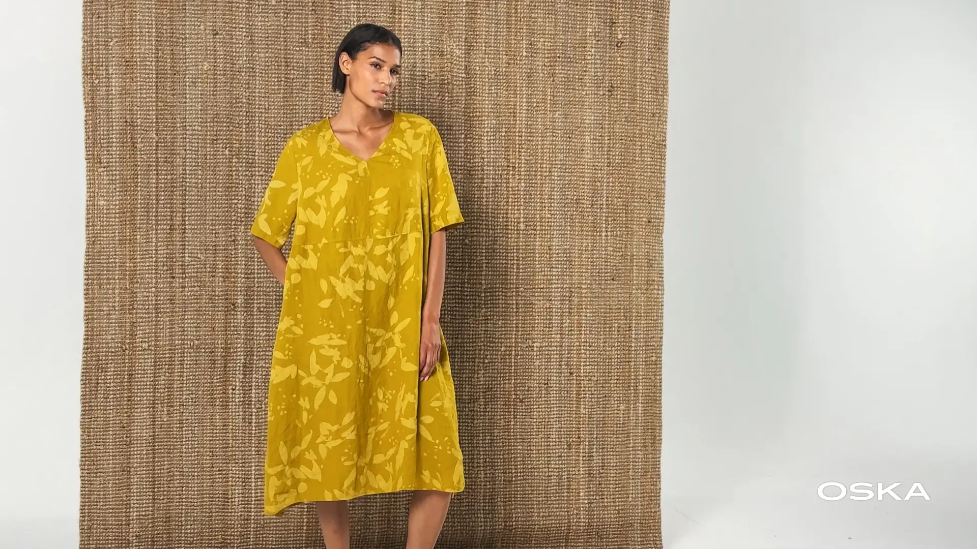 Model wearing a yellow floral dress