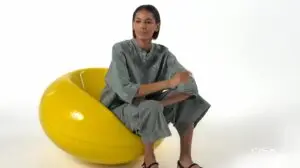 Person sitting in a yellow chair