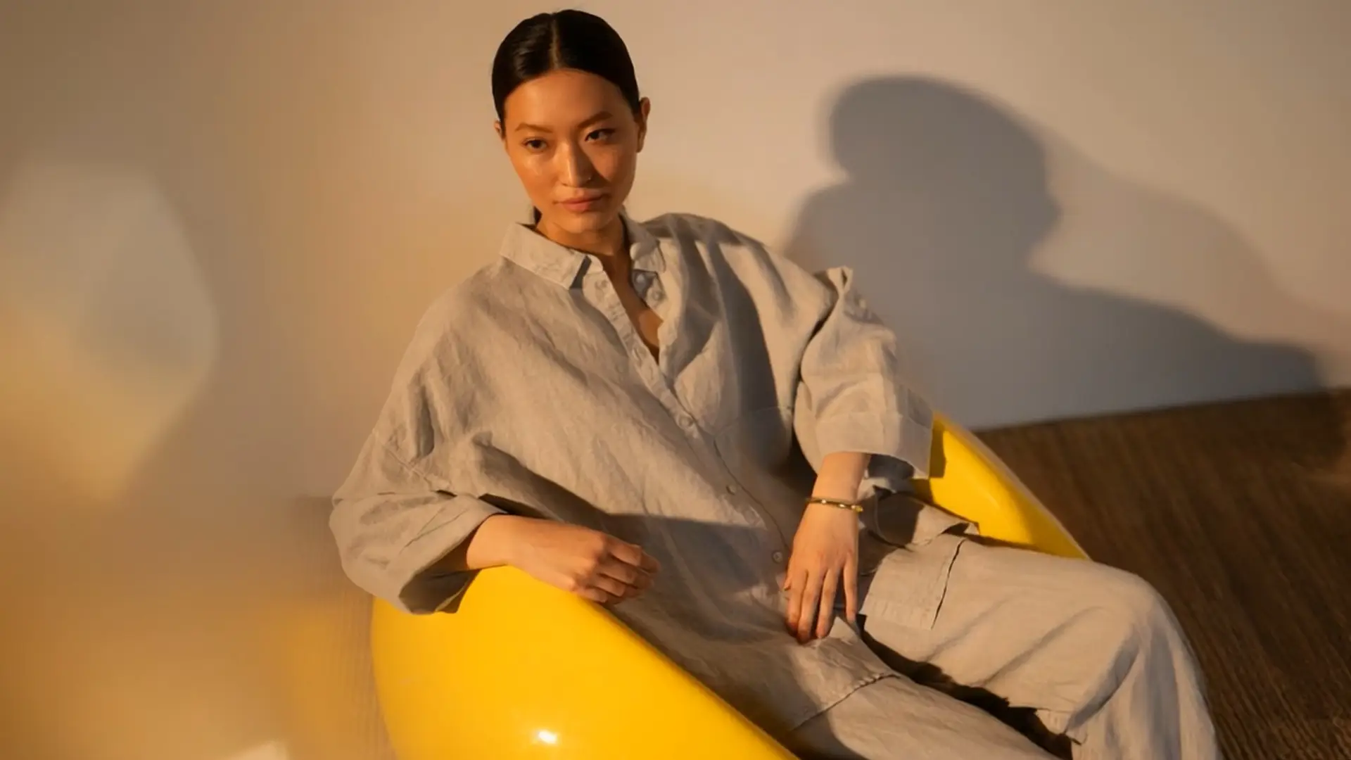 Person seated in a yellow chair