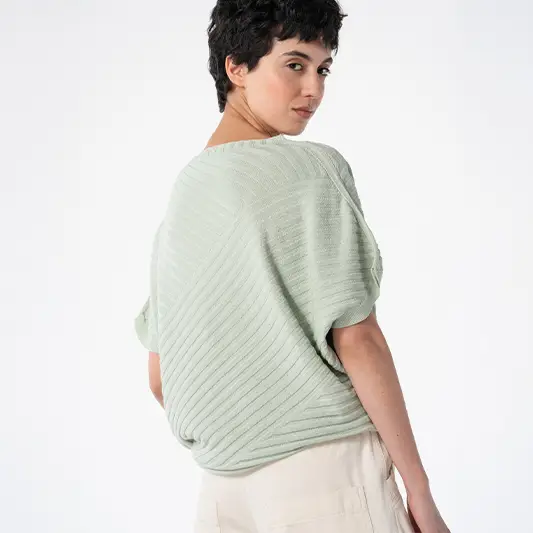 Woman in light green top and beige pants