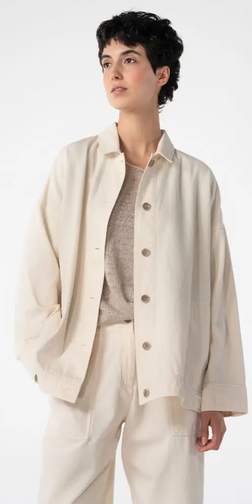 Model wearing a cream outfit