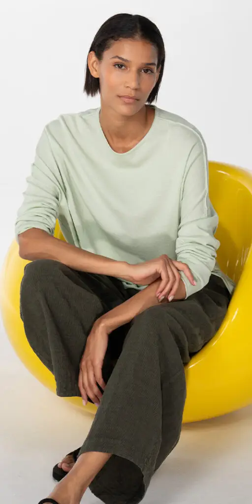 Model seated in a yellow chair
