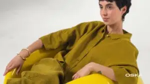Woman in mustard outfit reclining in yellow chair
