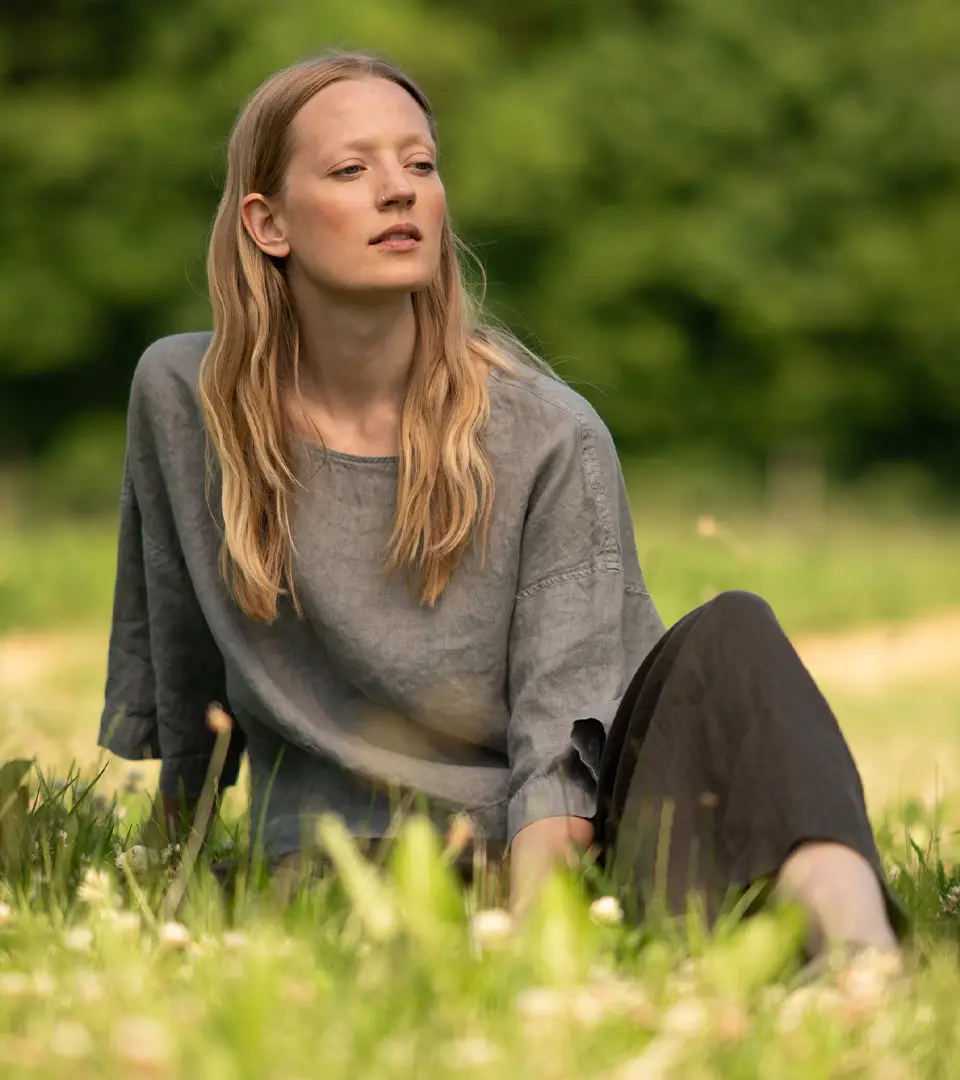 Woman sitting in a grassy field