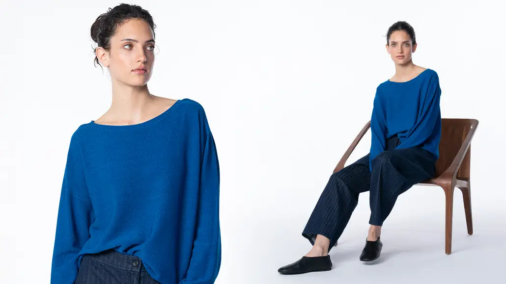 Woman in blue sweater sitting on wooden chair