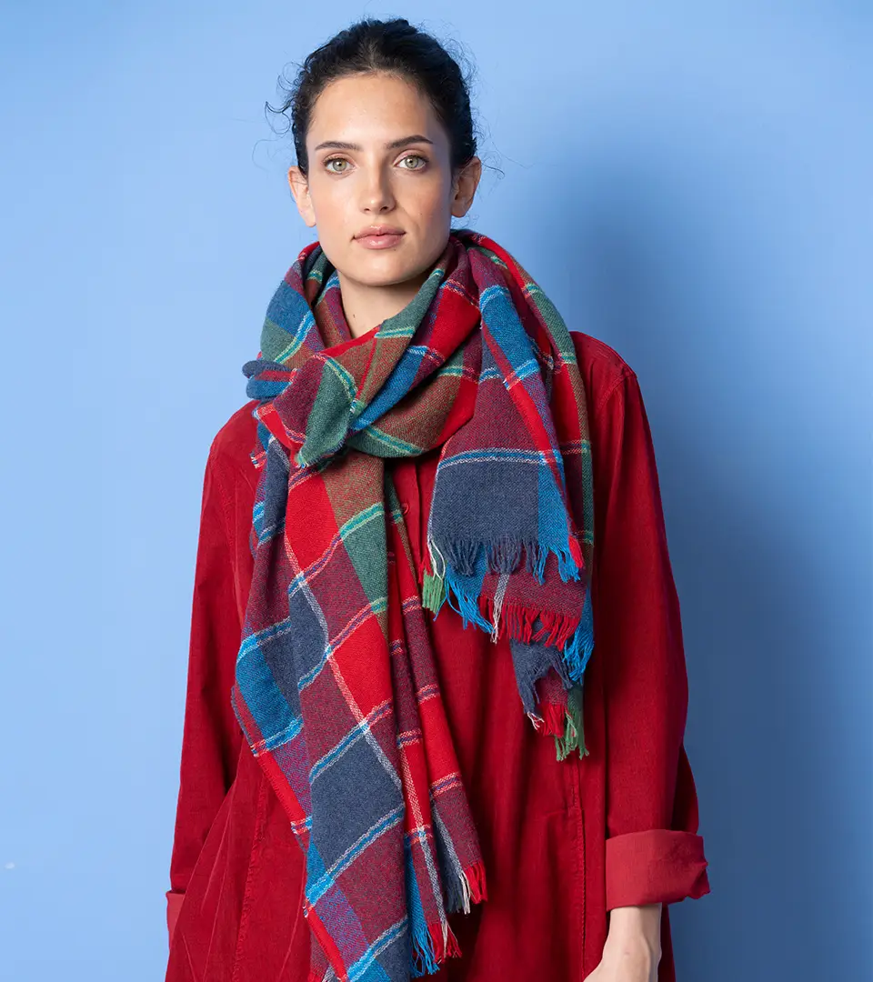 Woman in red dress with plaid scarf