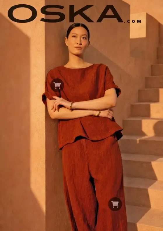Woman modeling stylish rust-colored outfit indoors.